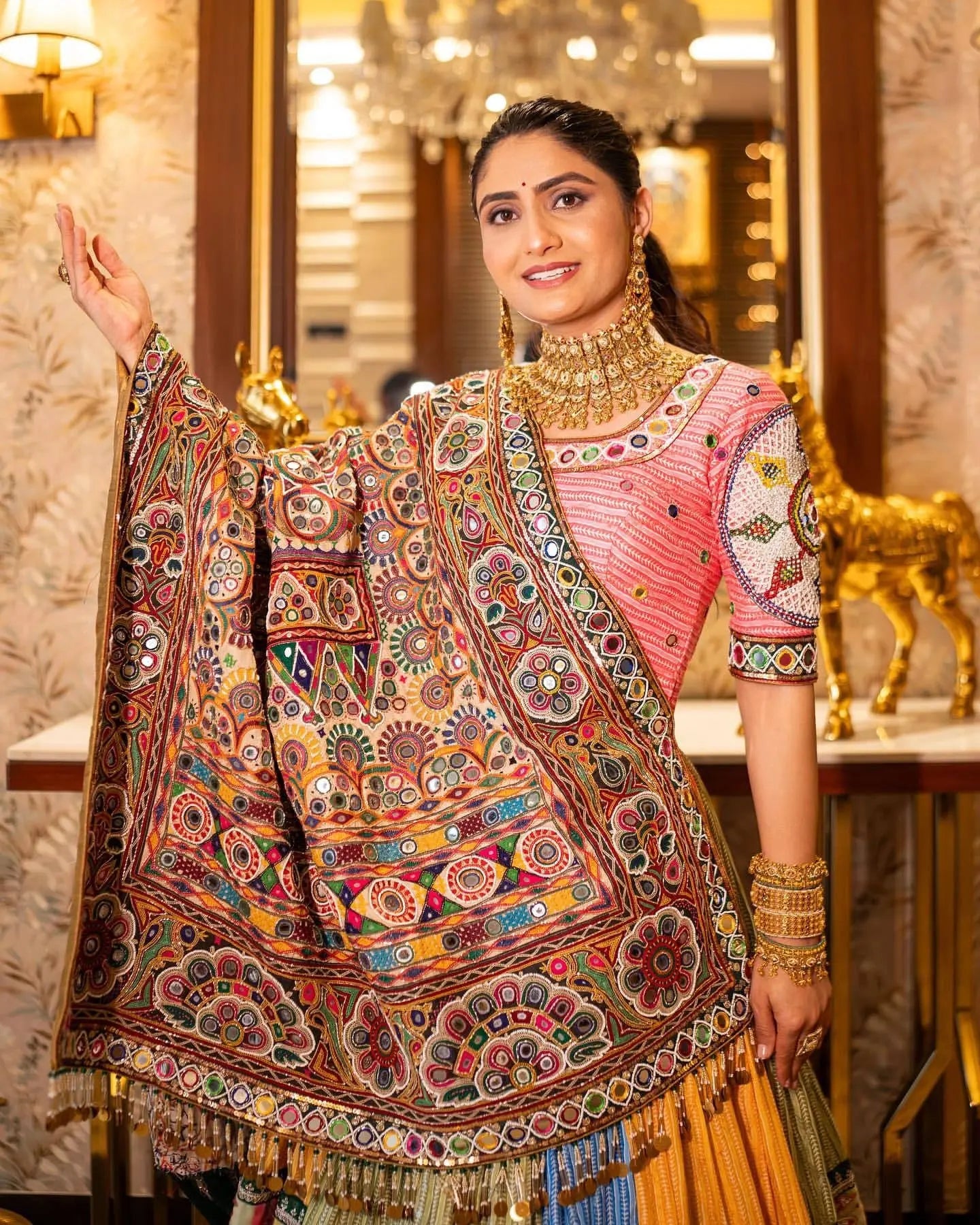 Woman wearing a traditional embroidered saree in an elegant interior setting